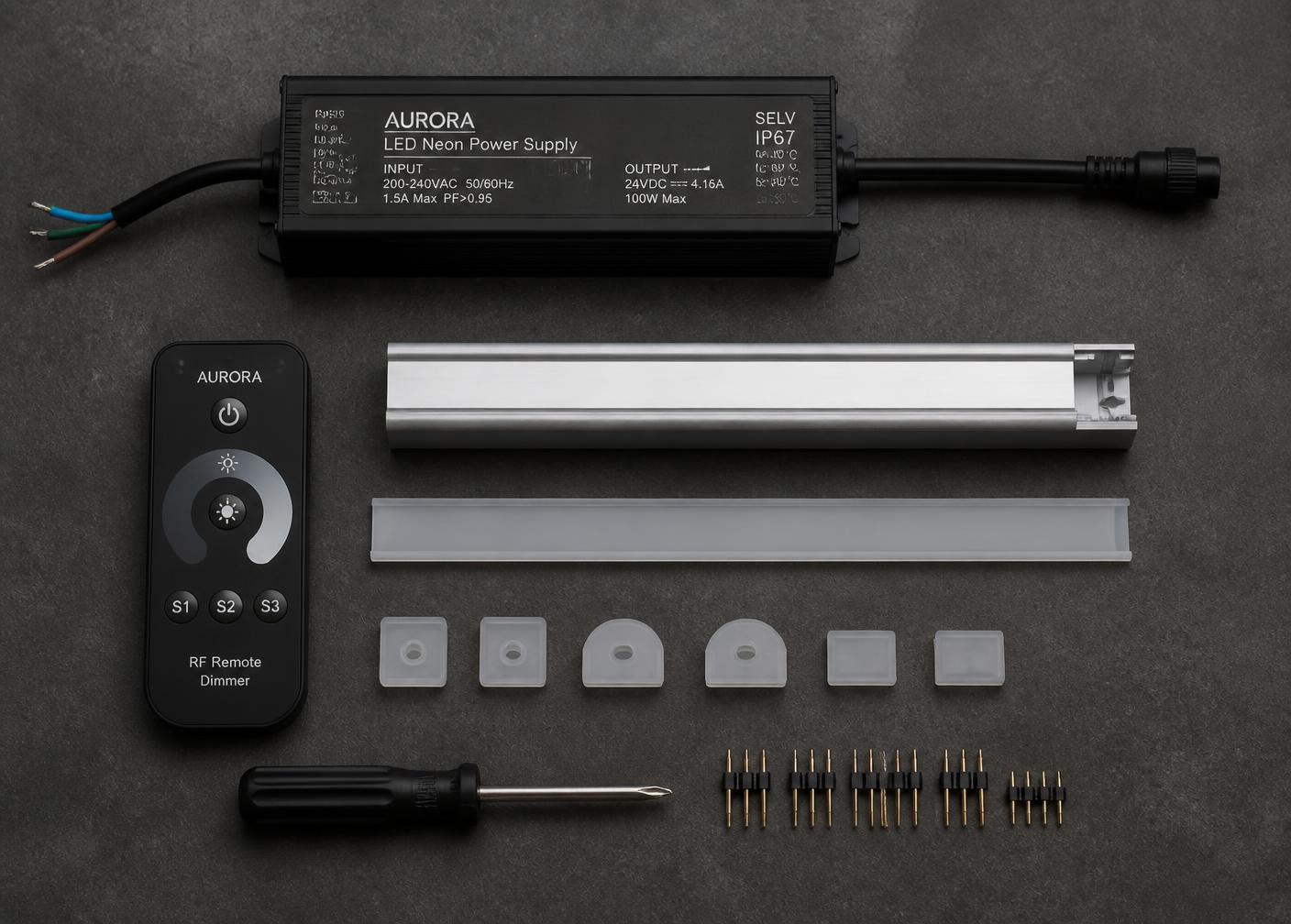 Flat lay of a 24V LED neon power supply, RF dimmer remote, aluminium channel, end caps and connector pins